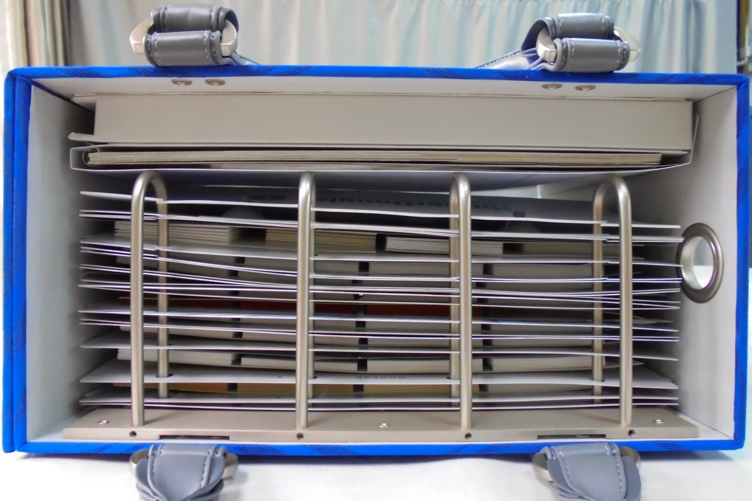 Hunter Douglas Rescue — Window cling integrated into sample book via ring attachment, primary storage position