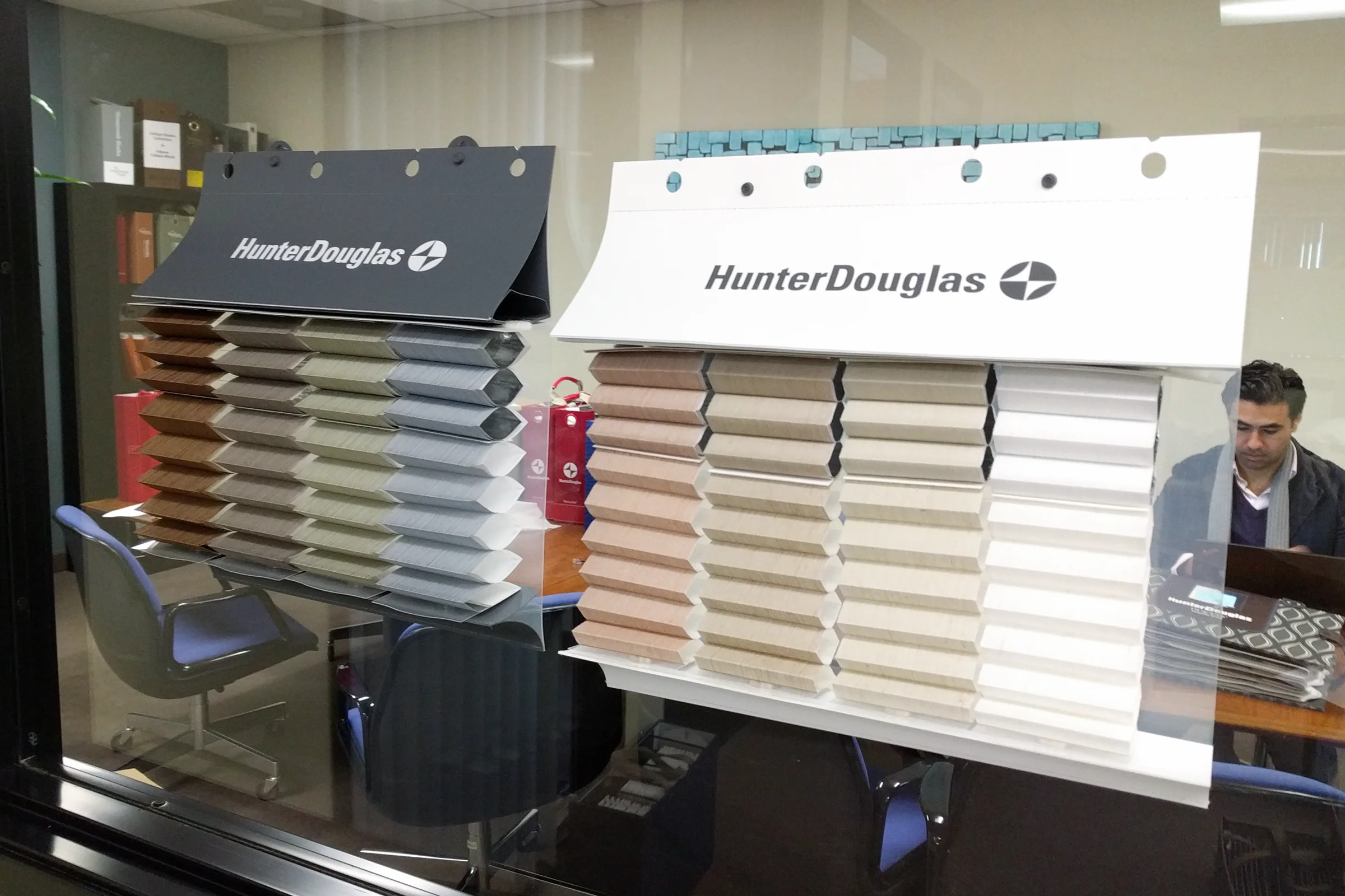 Hunter Douglas Rescue — Pre-production window cling prototype deployed on office window with honeycomb swatches expanded