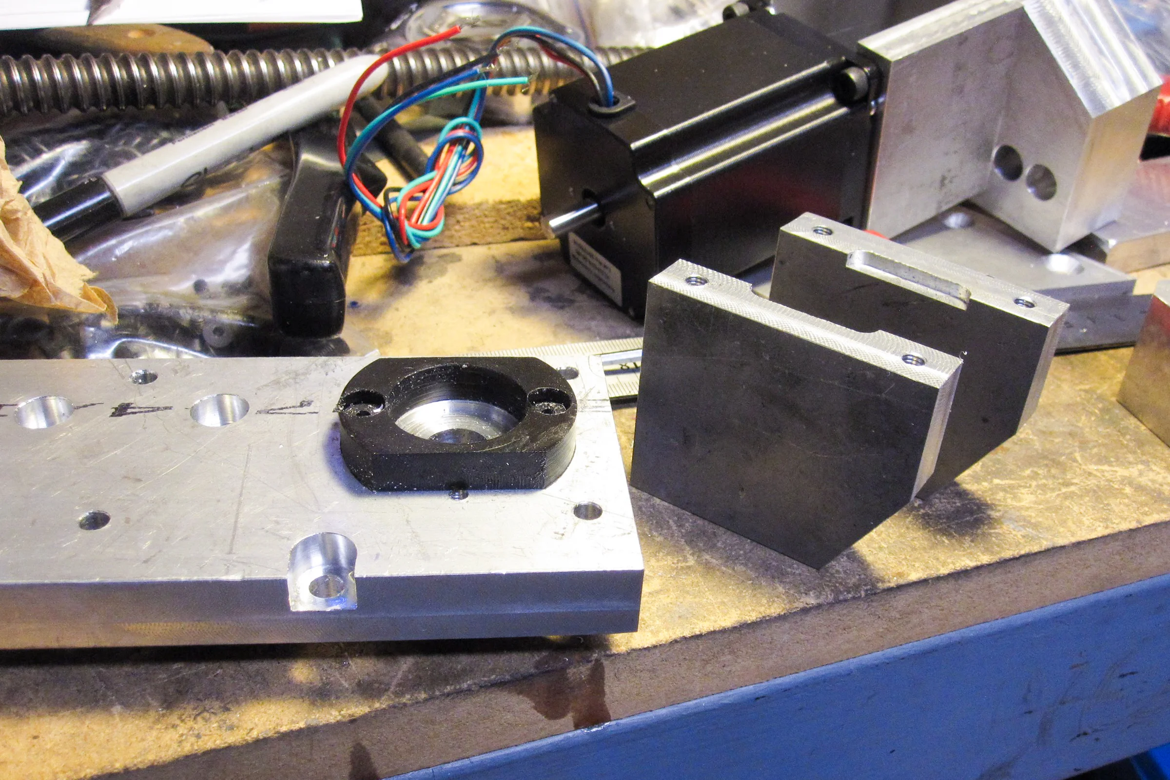 The Mill Trilogy — Ballscrew end support block being machined from 6061 aluminum for precise bearing location against LMS casting