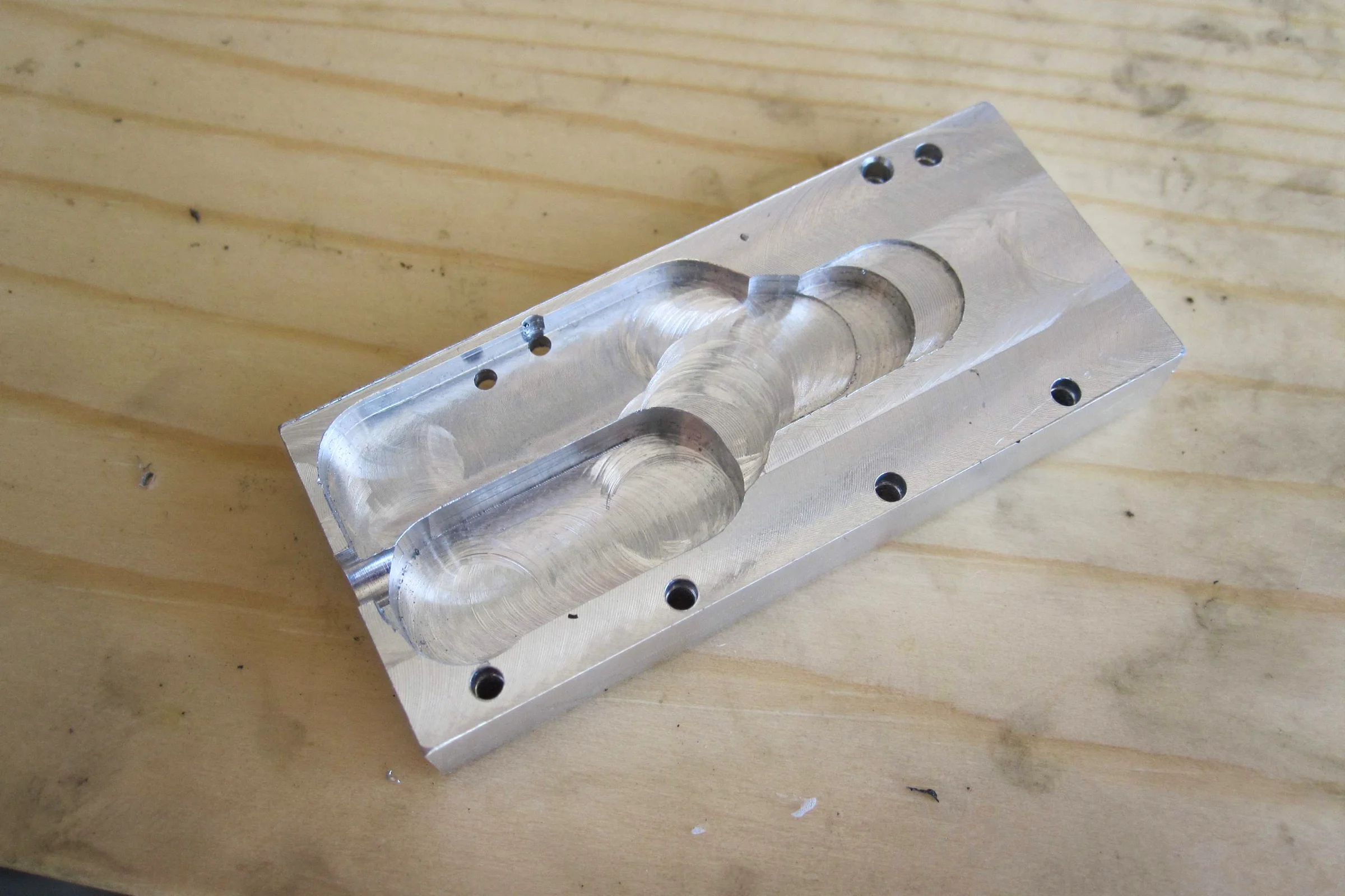 The Mill Trilogy — Custom milled aluminum low-profile cover replacing original caliper housing for internal table fitment