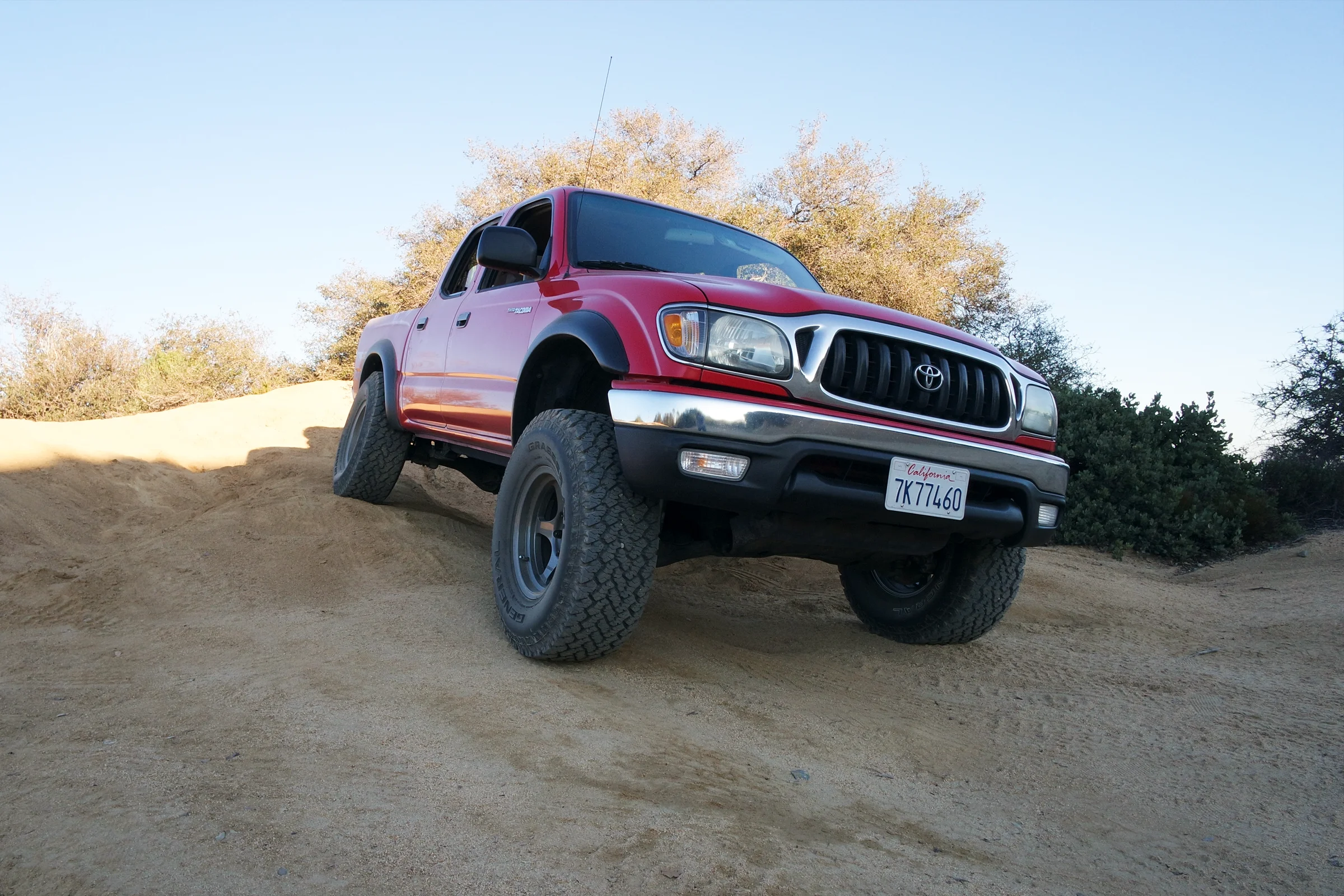 Suspension Geometry Correction — Lifted Toyota Tacoma on road with full suspension lift and corrected alignment at factory specification