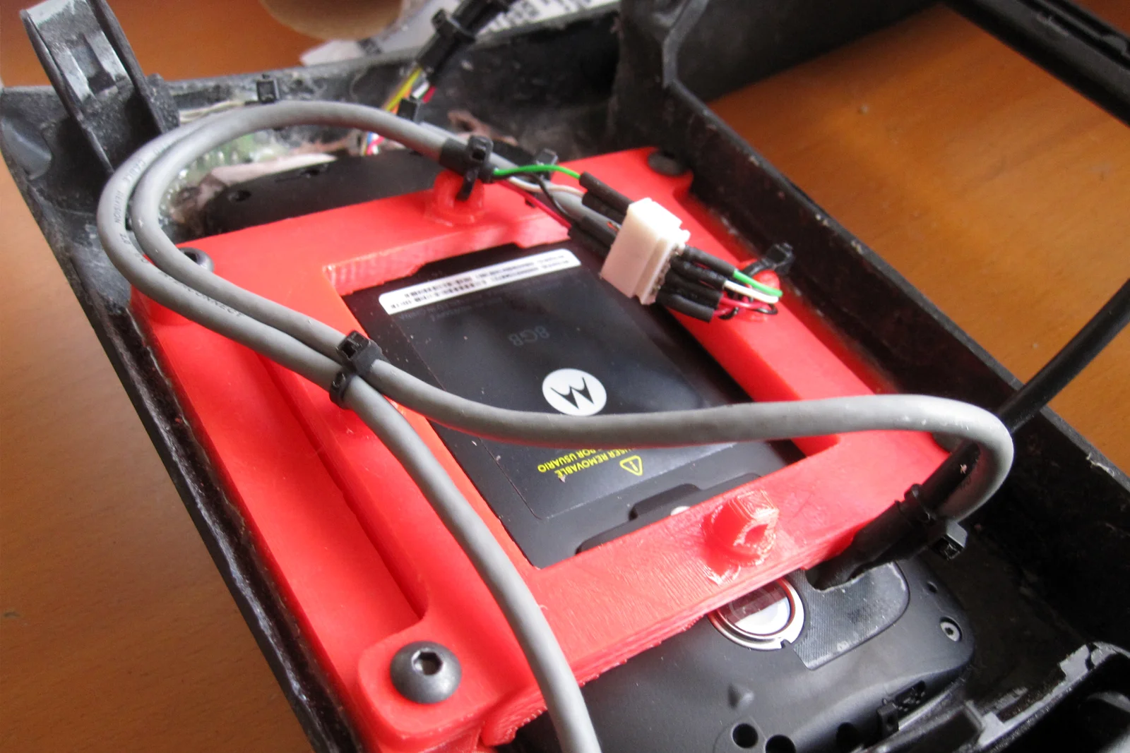 Vehicle Integrated Compute — Moto G phone disassembled with external button wiring and harness installed