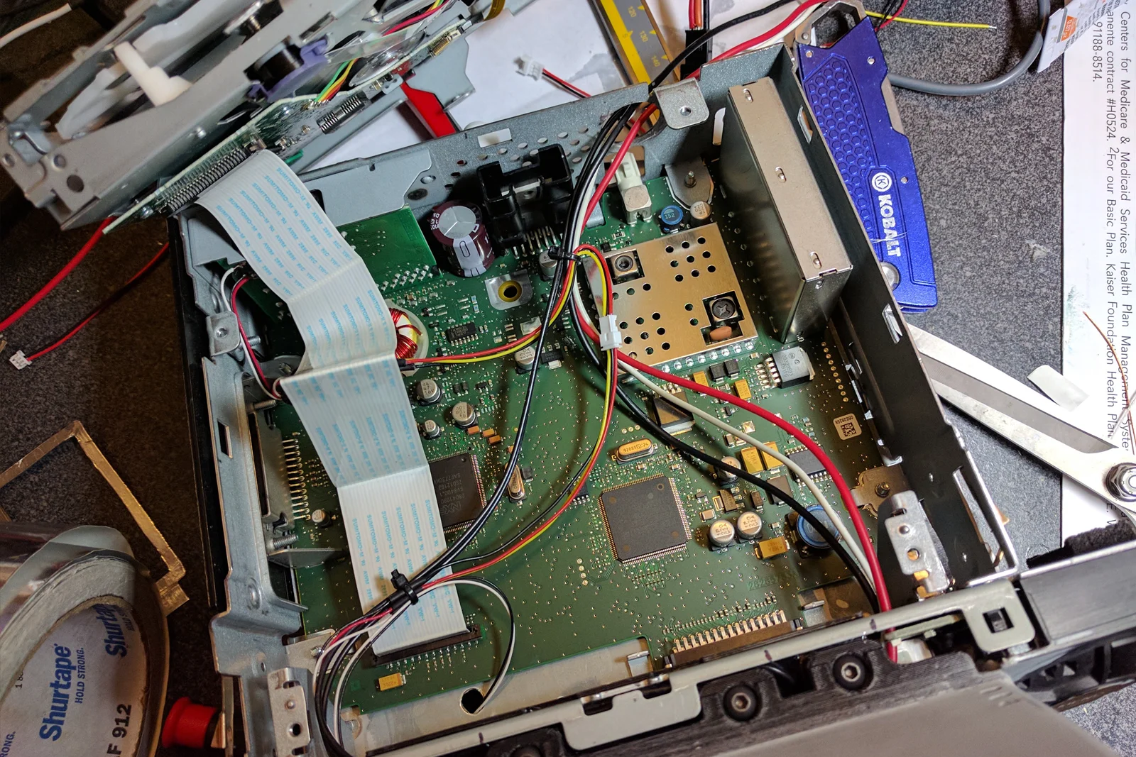 Vehicle Integrated Compute — Moto G phone disassembled with external button wiring and harness installed
